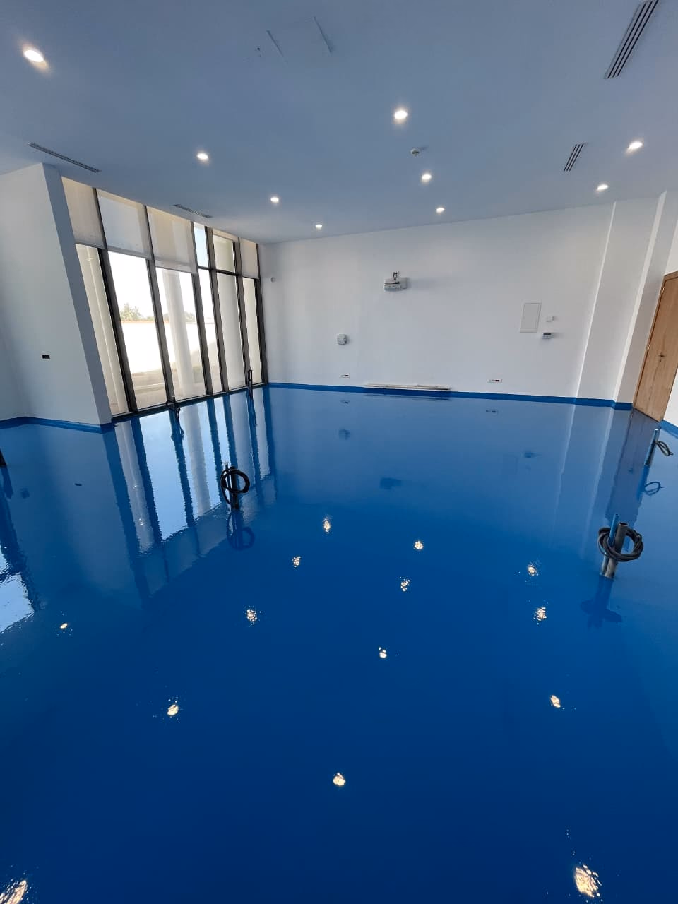 Fondation Lalla Asmaa : Salle au sol époxy bleu brillant baignée de lumière